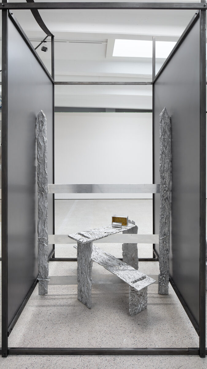 Detail of the large aluminium work by Maija Fox. A cubicle articulated with patinated steel profiles and sheets.